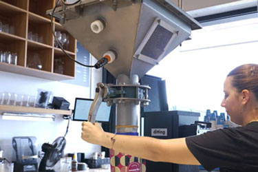 Visible Conveying of Freshly Roasted Beans Creates Unique Customer Experience at Merlo Coffee