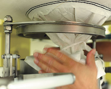 Norwegian Confectionery Maker Improves Safety, Stops Dust, Discharges Bulk Bags Automatically