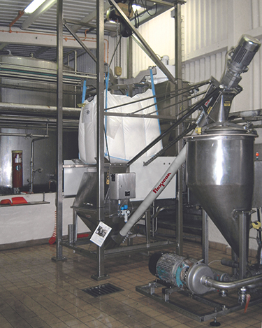 Dust-Tight Bulk Bag Discharger with Flexible Screw Conveyor Eliminates Waste, Improves Safety and Quality
