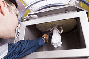 Discharger Dust Containment Enclosure Contains Bag Spout Leaks and Spills
